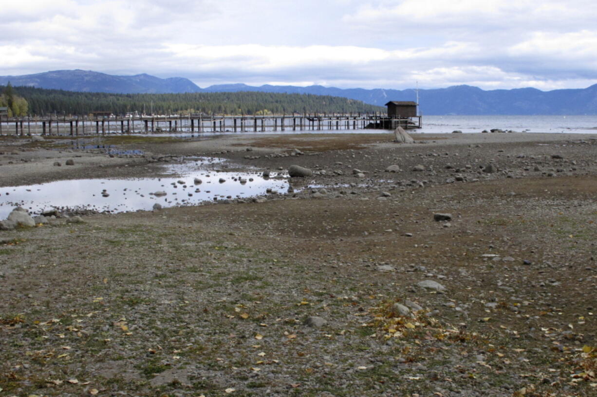 FILE - A pier and dock sits above Lake Tahoe's receding shoreline Wednesday, Oct. 20, 2021 at Tahoe City, Calif. There's no relief in sight for the West's record-shattering megadrought, which will likely only deepen this spring, the National Oceanic and Atmospheric Administration said in its seasonal outlook Thursday, March 17, 2022. But central and eastern states should be mostly spared from significant flooding.