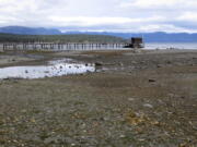 FILE - A pier and dock sits above Lake Tahoe's receding shoreline Wednesday, Oct. 20, 2021 at Tahoe City, Calif. There's no relief in sight for the West's record-shattering megadrought, which will likely only deepen this spring, the National Oceanic and Atmospheric Administration said in its seasonal outlook Thursday, March 17, 2022. But central and eastern states should be mostly spared from significant flooding.