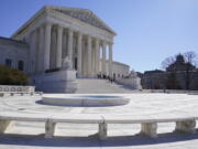 FILE - People stand on the steps of the U.S. Supreme Court, Feb.11, 2022, in Washington.