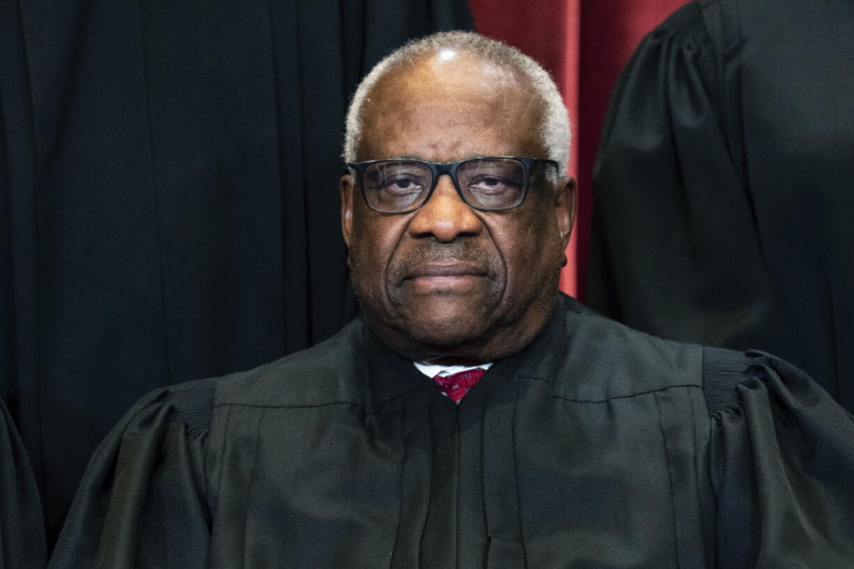 FILE - Justice Clarence Thomas sits during a group photo at the Supreme Court in Washington, on Friday, April 23, 2021. Thomas has been hospitalized because of an infection, the Supreme Court said Sunday, March 20, 2022. Thomas, 73, has been at Sibley Memorial Hospital in Washington, D.C., since Friday, March 18 after experiencing "flu-like symptoms," the court said in a statement.