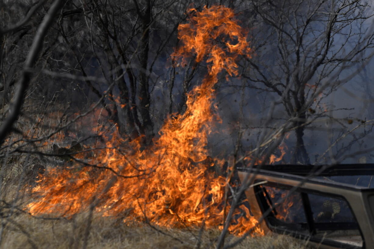 Flames quickly spread through dry grass west of Abilene, Texas near Old Highway 80 Thursday, March 17, 2022. The grass fire quickly spread southeast, jumping the roadway, continuing in the same direction until it jumped South First Street and threatened a mobile home park which was evacuated. (Ronald W.