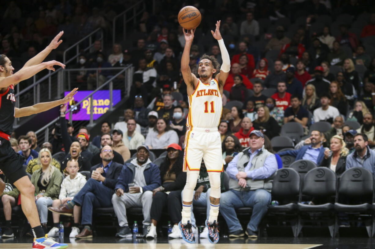 Atlanta Hawks guard Trae Young shoots in the first half of an NBA basketball game against the Portland Trail Blazers, Monday, March 14, 2022, in Atlanta.