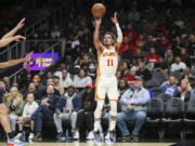 Atlanta Hawks guard Trae Young shoots in the first half of an NBA basketball game against the Portland Trail Blazers, Monday, March 14, 2022, in Atlanta.