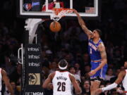 New York Knicks' Obi Toppin (1) dunks against the Portland Trail Blazers during the second quarter of an NBA basketball game Wednesday, March 16, 2022, in New York.