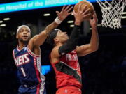 Portland Trail Blazers guard Josh Hart (11) shoots against Brooklyn Nets forward Bruce Brown (1) in the first half of an NBA basketball game, Friday, March 18, 2022, in New York.