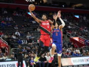 Portland Trail Blazers guard Brandon Williams (8) drives on Detroit Pistons guard Cade Cunningham (2) in the second half of an NBA basketball game in Detroit, Monday, March 21, 2022.