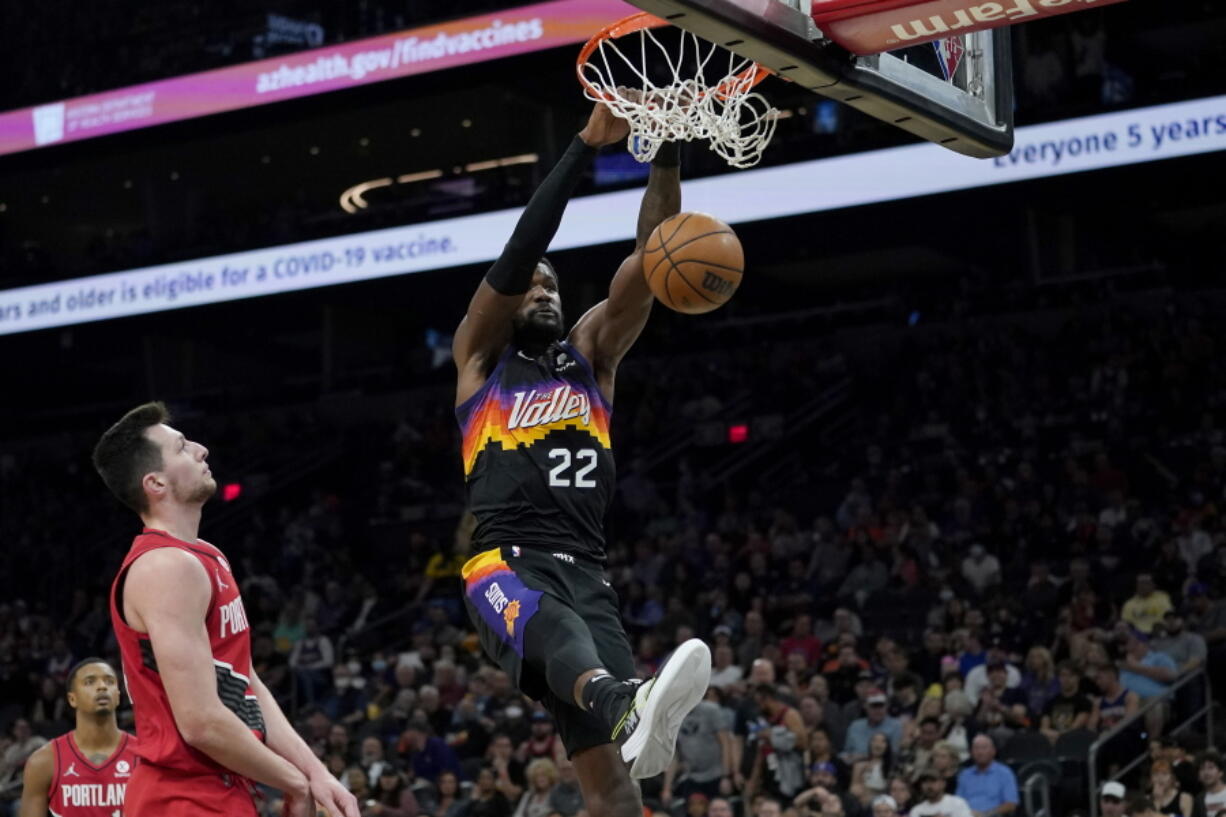 Phoenix Suns center Deandre Ayton (22) dunks against the Portland Trail Blazers during the second half of an NBA basketball game, Wednesday, March 2, 2022, in Phoenix.