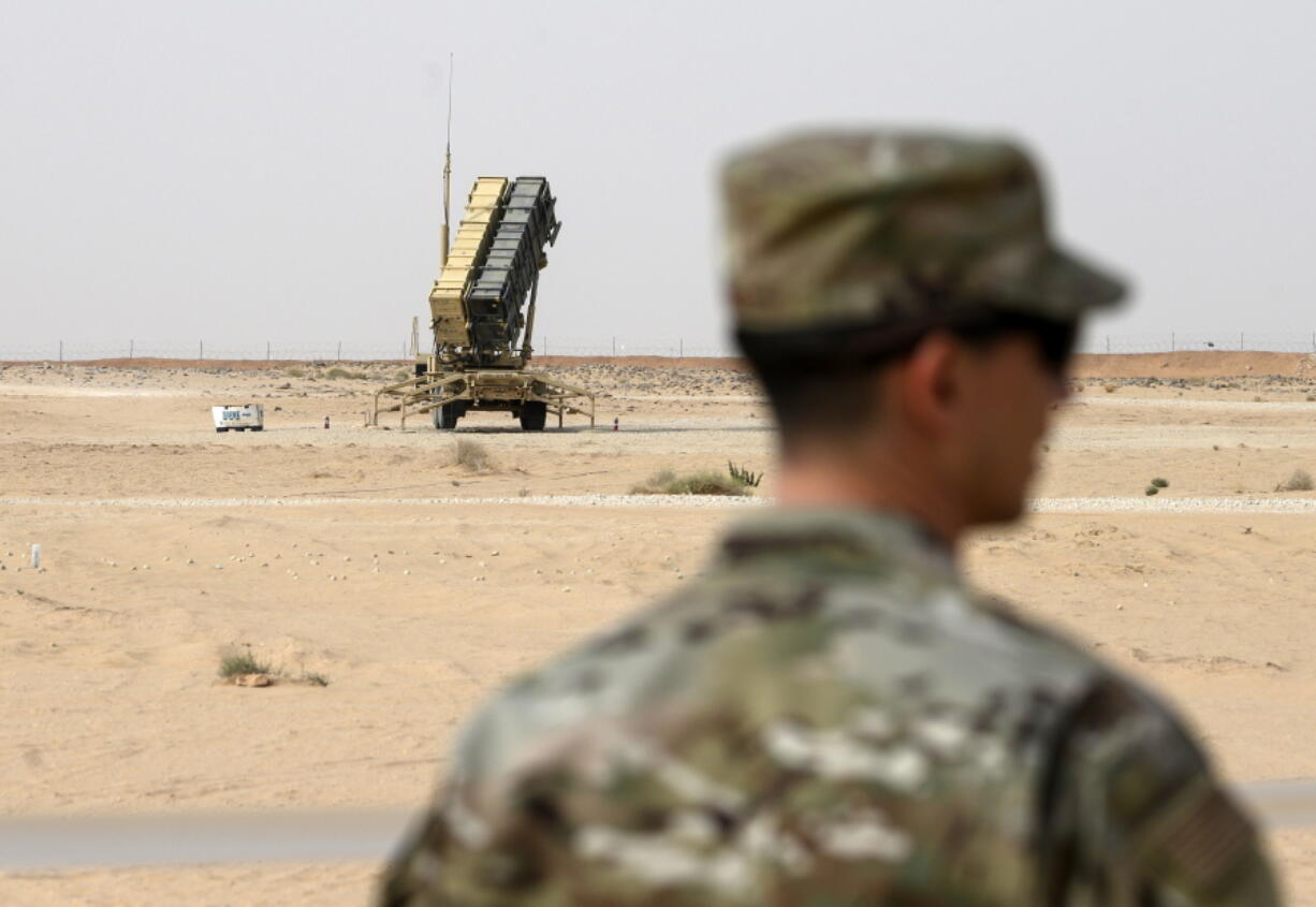 FILE - A member of the U.S. Air Force stands near a Patriot missile battery at the Prince Sultan air base in al-Kharj, central Saudi Arabia, on Feb. 20, 2020. The U.S. has transferred a significant number of Patriot antimissile interceptors to Saudi Arabia in recent weeks as the Biden administration looks to ease what has been a point of tension in the increasingly complicated U.S.-Saudi relationship.