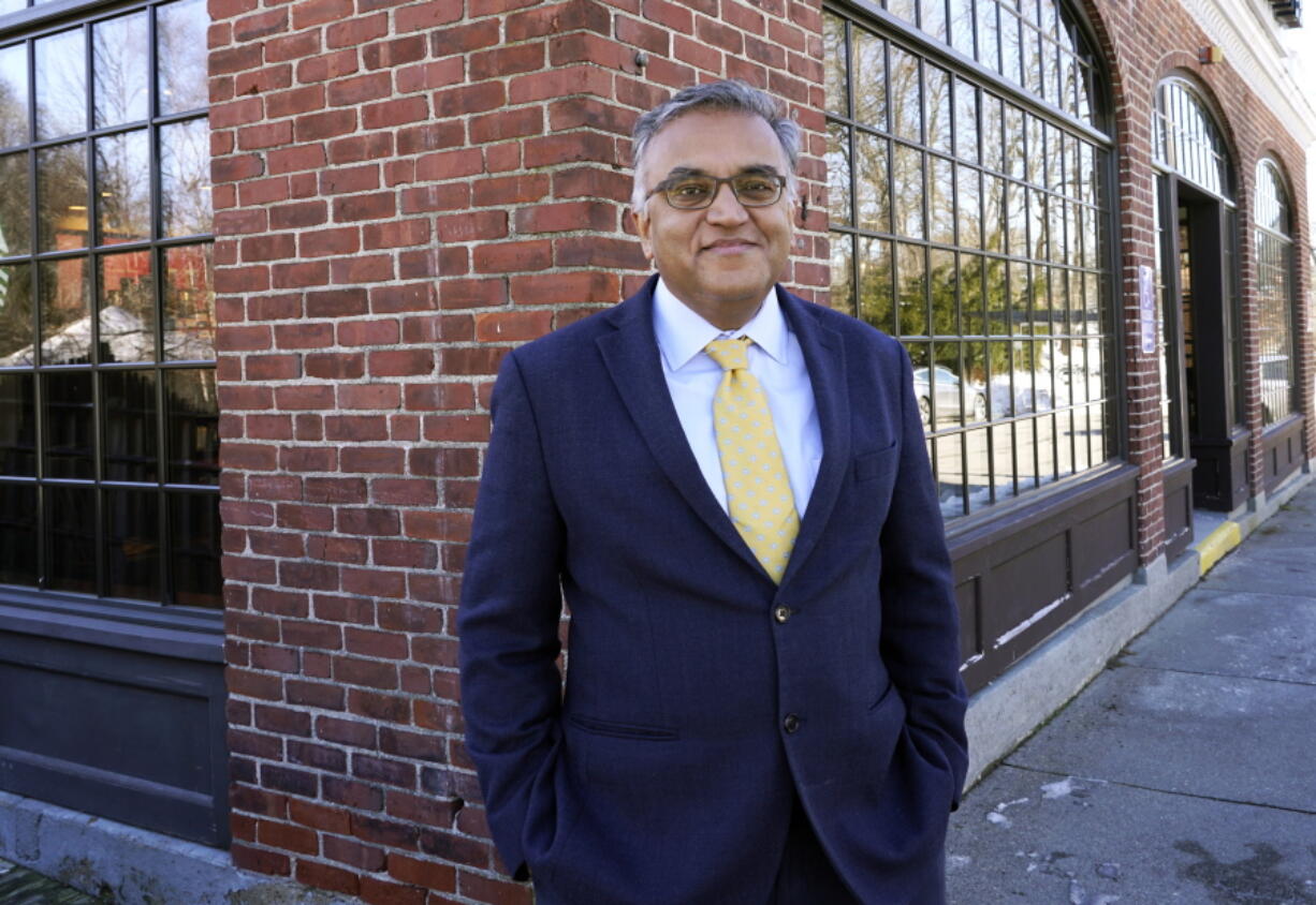 FILE - Dr. Ashish Jha, dean of Brown University's School of Public Health, poses for a photo Dec. 23, 2020, in Newton, Mass. President Joe Biden's COVID-19 coordinator Jeff Zients and his deputy Natalie Quillian are leaving the administration next month, the White House announced Thursday, March 17, 2022. They will be replaced by Dr. Ashish Jha.