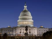 FILE - The U.S. Capitol building is seen before sunrise on Capitol Hill in Washington, Monday, March. 21, 2022. With an urgent funding request stuck in Congress, the Health Resources and Services Administration says it can no longer cover medical bills for COVID tests and treatments for uninsured people and will stop taking claims at midnight Tuesday.