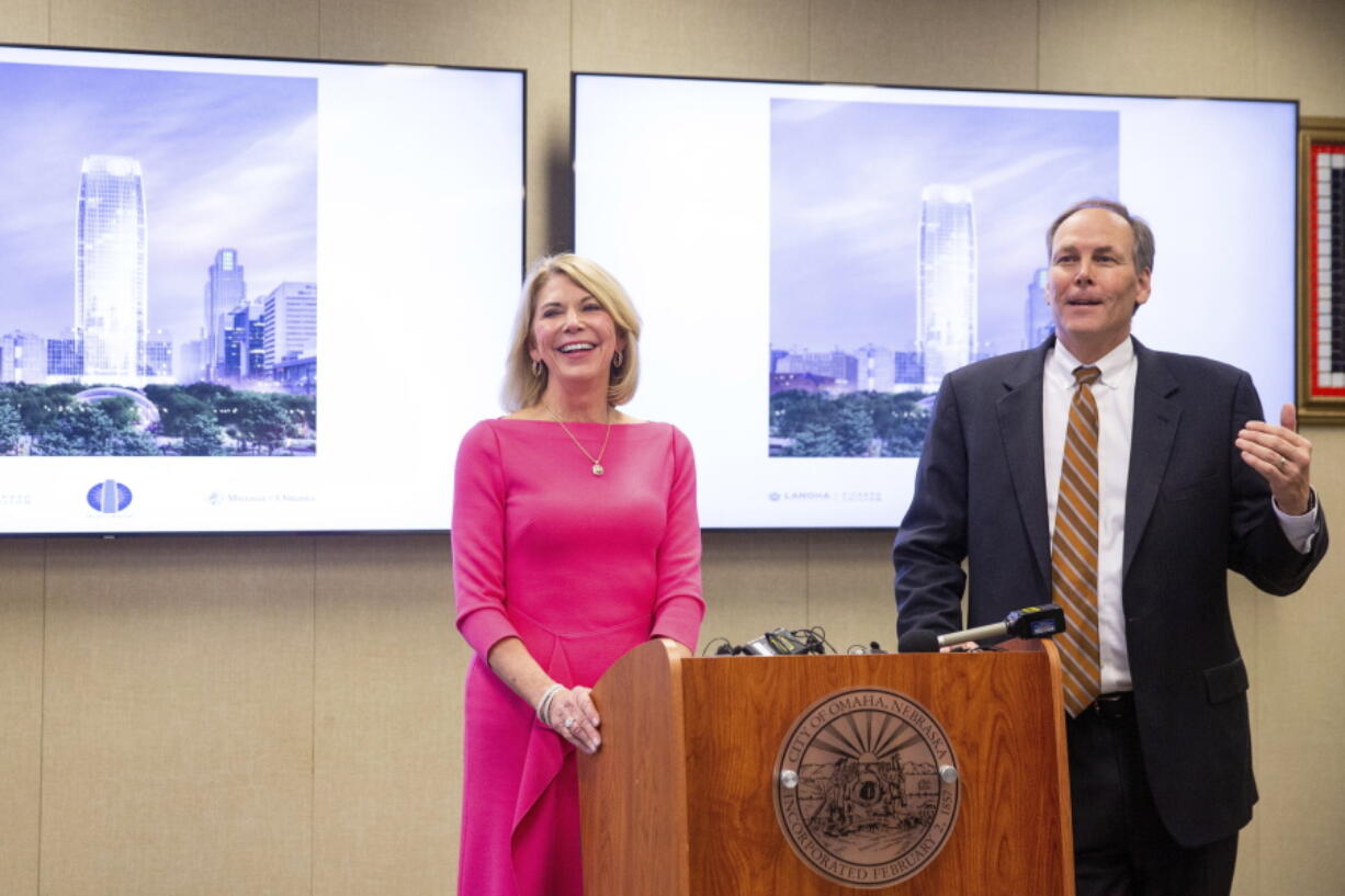 Omaha Mayor Jean Stothert, left, and Mutual of Omaha CEO James Blackledge announce plans for a new Mutual of Omaha headquarters skyscraper on the site of the current downtown library, Wednesday, Jan. 26, 2022. Many companies are recommitting to office space and moving forward with major projects because they believe working in person is better for collaboration and training younger employees. The plans also include building a three-mile streetcar system that would run from the riverfront to Nebraska Medicine.