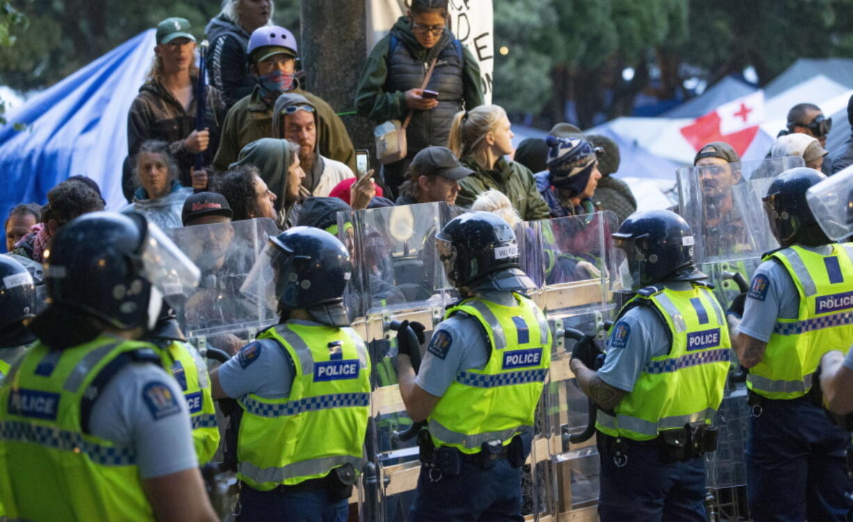 Demonstrators and police face off at a protest opposing vaccine mandates today in Wellington, New Zealand.