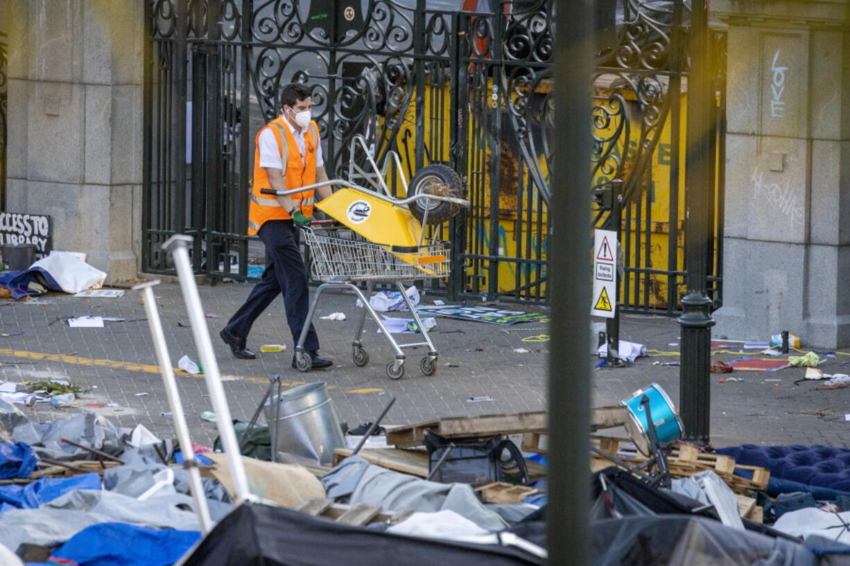 Workers start the clean up of Parliament grounds following weeks of protests Thursday in Wellington, New Zealand.