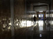 FILE - A student walks down a hallway between classes at a high school in Kansas City, Kan., on the first day of in-person learning Wednesday, March 30, 2021. According to a study by the Centers for Disease Control and Prevention released on Thursday, March 31, 2022, nearly half of U.S. high school students said they felt persistently sad or hopeless during the COVID-19 pandemic, and many said they suffered emotional or physical abuse by a parent or other adult in the home.