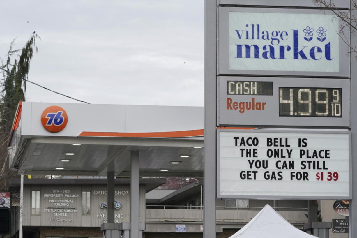 A sign at a gas station near the University of Washington makes a humorous statement about rising gas prices Friday in Seattle. (TED S.