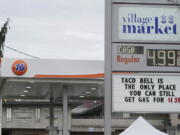 A sign at a gas station near the University of Washington makes a humorous statement about rising gas prices Friday in Seattle. (TED S.