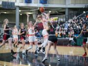 Washougal's Savea Mansfield, center, flips in a shot in a Class 2A girls state fourth-place semifinal game against Archbishop Murphy on Friday at the Yakima Valley SunDome.