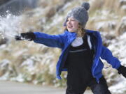 Ian Mattson, 9, throws a snowball at his sister Elise, 5, as they play in Renaissance Park on Saturday, March 12, 2022 In Chattanooga, Tenn.