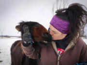 Kym Garvey gives Lemon the donkey a kiss on the snout. Lemon was born with wry nose, which makes her look different from other donkeys, causing them to shun her. More than 43 equine were under the care of Kym Garvey at Save The Brays Donkey Rescue Friday, March 10, 2022, in Milaca, Minnestota. (Shari L. Gross/Minneapolis Star Tribune/TNS) (Shari L.