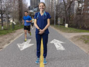 Penn nurse Sam Roecker is running the Boston Marathon in nursing scrubs, raising funds to support nurses' mental health and wellbeing. She sometimes trains on the Schuylkill River Trail, logging up to 100 miles a week. (Alejandro A.