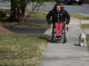 Tatyana McFadden takes Bentley for a walk near her family???s home in Clarksville, Maryland.