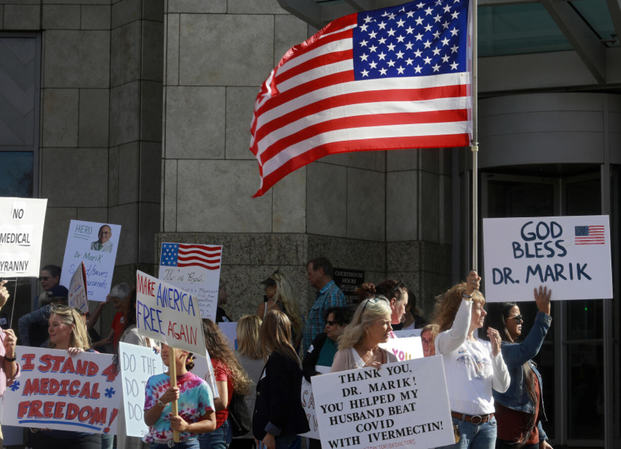 Supporters of Dr. Paul Marik gather along St. Pauls Boulevard outside of the Norfolk, Virginia, courthouse on Nov. 18, 2021. Dr. Marik, a critical care specialist, sued Sentara Healthcare over its ban of the use of ivermectin in COVID-19 patients. Legislators in at least half the states are trying to protect medical providers from disciplinary action for spreading misinformation about COVID-19 or promoting unproven treatments, which some medical authorities say endanger the public.