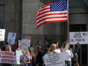 Supporters of Dr. Paul Marik gather along St. Pauls Boulevard outside of the Norfolk, Virginia, courthouse on Nov. 18, 2021. Dr. Marik, a critical care specialist, sued Sentara Healthcare over its ban of the use of ivermectin in COVID-19 patients. Legislators in at least half the states are trying to protect medical providers from disciplinary action for spreading misinformation about COVID-19 or promoting unproven treatments, which some medical authorities say endanger the public.