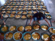 Volunteers prepare iftar food plates April 4 for Muslim devotees before breaking their fast on the holy fasting month of Ramadan in Karachi, Pakistan.