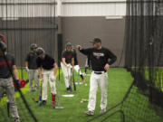 Camas baseball coach Stephen Short instructs his players during a practice Tuesday at Camas High School's Fieldhouse, an indoor practice facility.