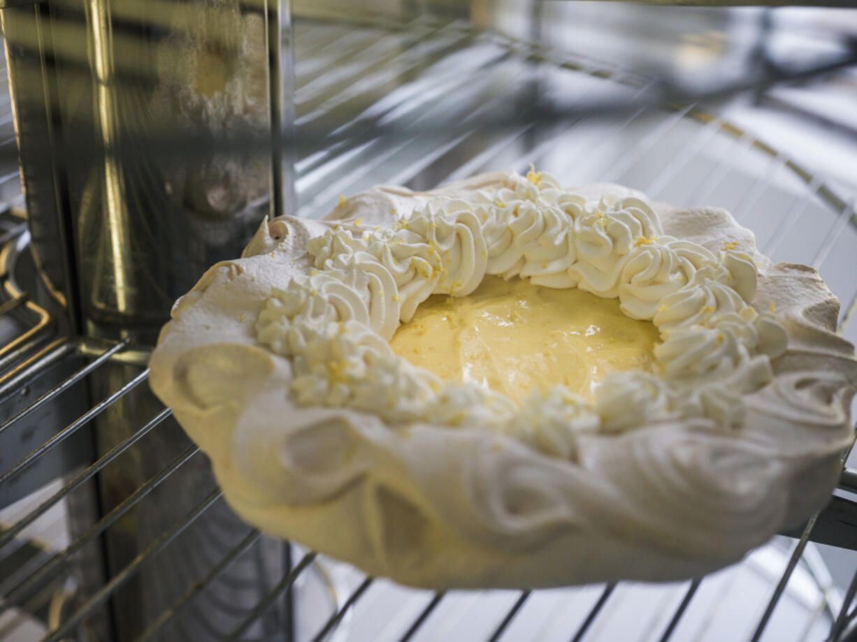 Rachel Swan puts the finished angel pie in the presentation refrigerator in Minneapoli.