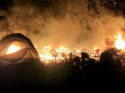 A fire destroyed a tent and other possessions at a homeless camp in east Vancouver in May 2021.