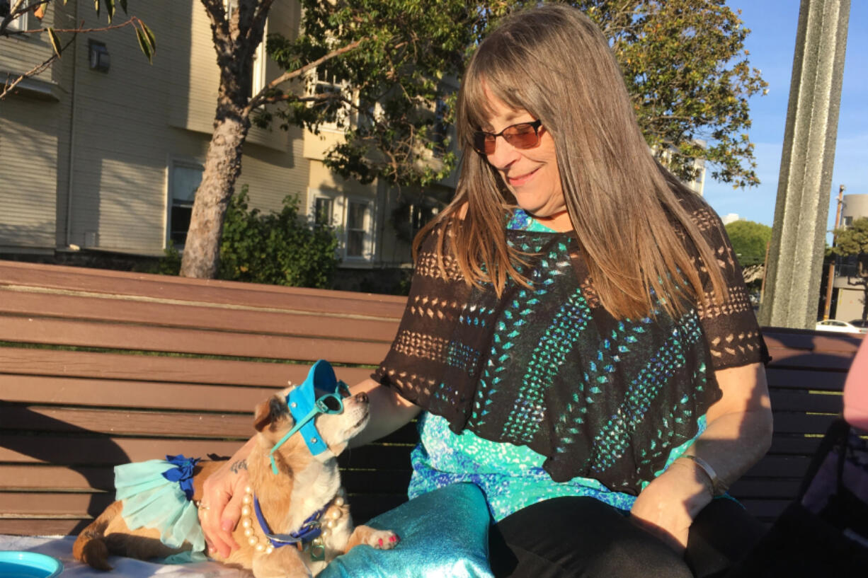 Diana McAllister lounges with her dog, Honey, at a park in San Francisco. Some pet owners in the area report waiting months for veterinarian appointments.