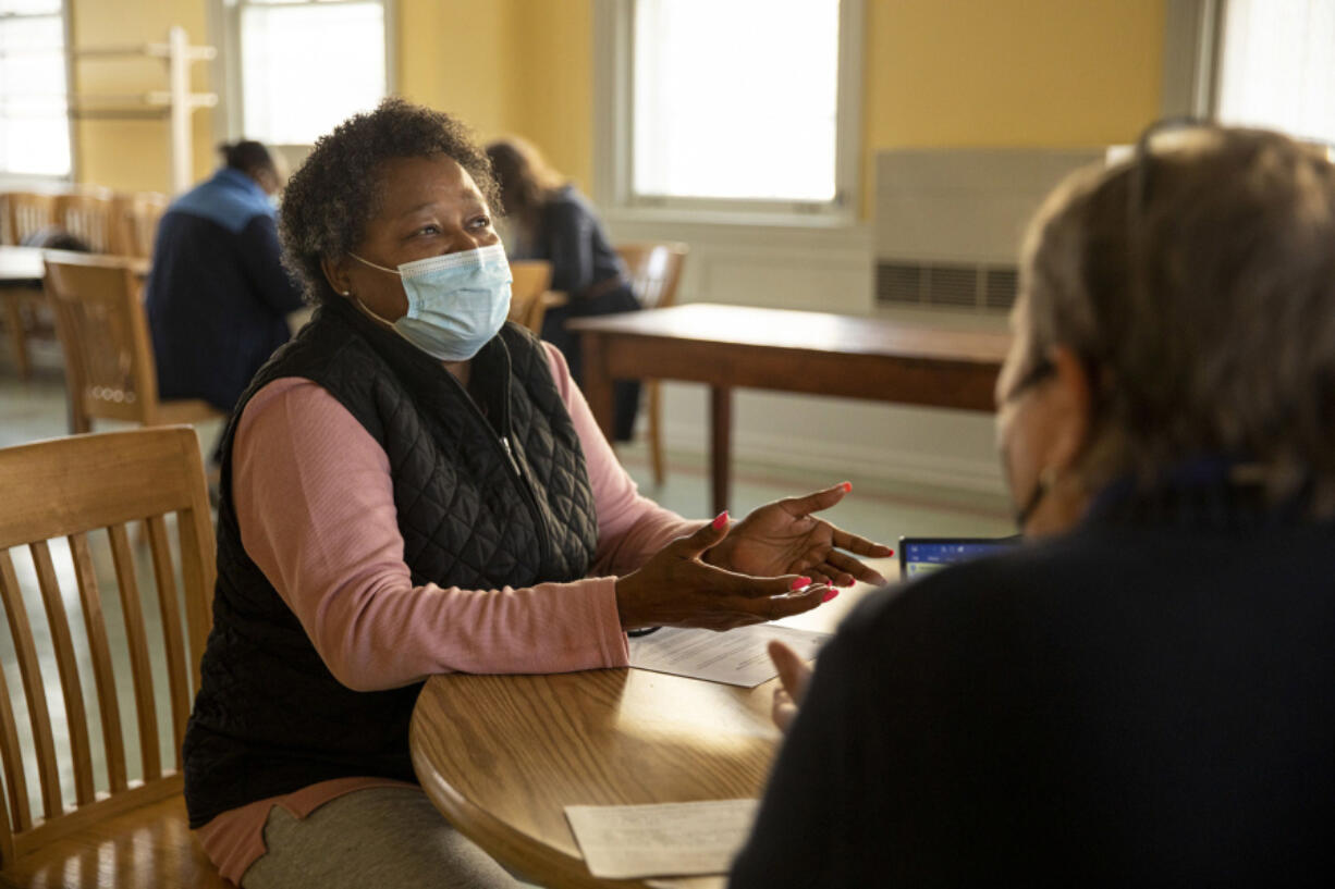 Linda Smalley, 63, of Germantown came in for the Green Street Friends Meeting Legal Clinic seeking information and help from Viv Hawkins, 68, of Mount Airy, a member of the Green Streets Reparations Committee.