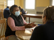 Linda Smalley, 63, of Germantown came in for the Green Street Friends Meeting Legal Clinic seeking information and help from Viv Hawkins, 68, of Mount Airy, a member of the Green Streets Reparations Committee.