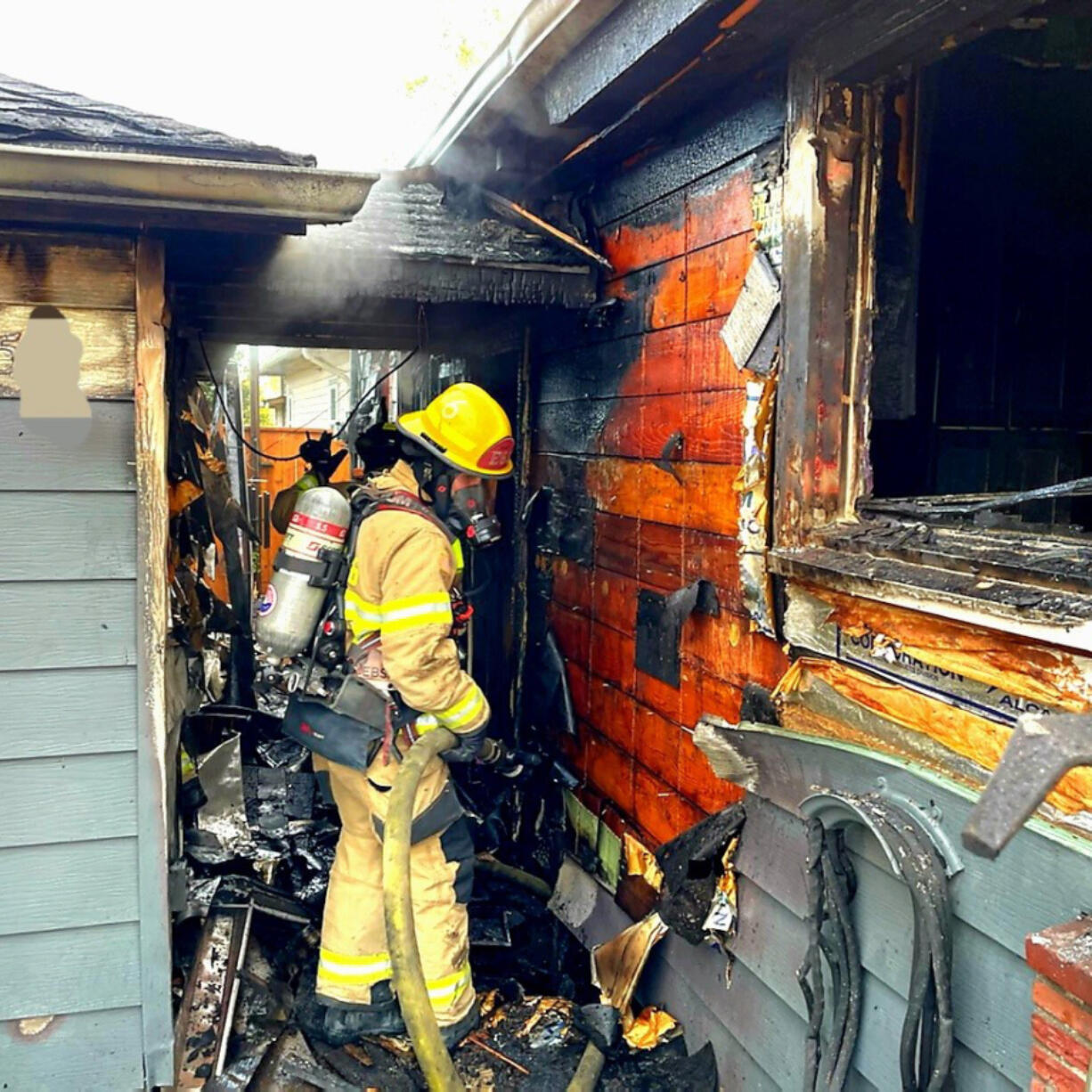 Vancouver firefighters extinguish a garage fire Saturday in the Shumway neighborhood. The homeowners told firefighters everyone escaped the house safely, and no one was injured.