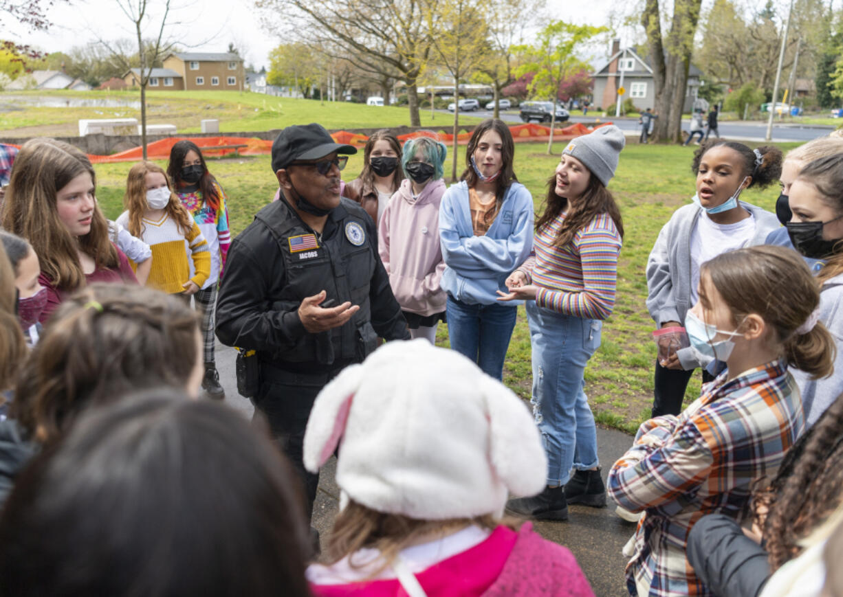 Vancouver Public Schools District Resource Officer Tony Jacobs, center, tells a crowd of Vancouver School of Arts and Academics students on Tuesday that he is retiring at the end of the school year.