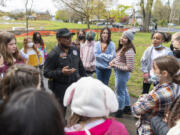 Vancouver Public Schools District Resource Officer Tony Jacobs, center, tells a crowd of Vancouver School of Arts and Academics students on Tuesday that he is retiring at the end of the school year.