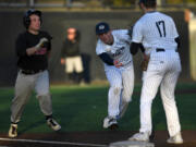 Skyview's Cody Blackhurst, center, lobs the ball to Brady Davis, right, to put out Union's Devon Woods, left, during Wednesday's 4A Greater St. Helens League game at Propstra Stadium. All four 4A GSHL teams will be in a tight battle this season for three playoff berths.