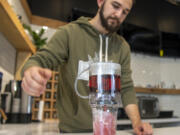 IV Tea Co. owner Michael Hearn III brews a cup of papaya blackberry fruit tea with edible glitter at IV Tea on Broadway in Vancouver.