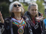 Estelita Little Star Robinson, a U.S. Army veteran, looks to the sky while the drum and singing circle performs during the Chief Redheart ceremony Saturday at the Fort Vancouver National Historic Site. The memorial event pays tribute to the Nez Perce tribal leader and his band of 33 members who were captured from their homeland in Idaho and imprisoned at Fort Vancouver in 1877.