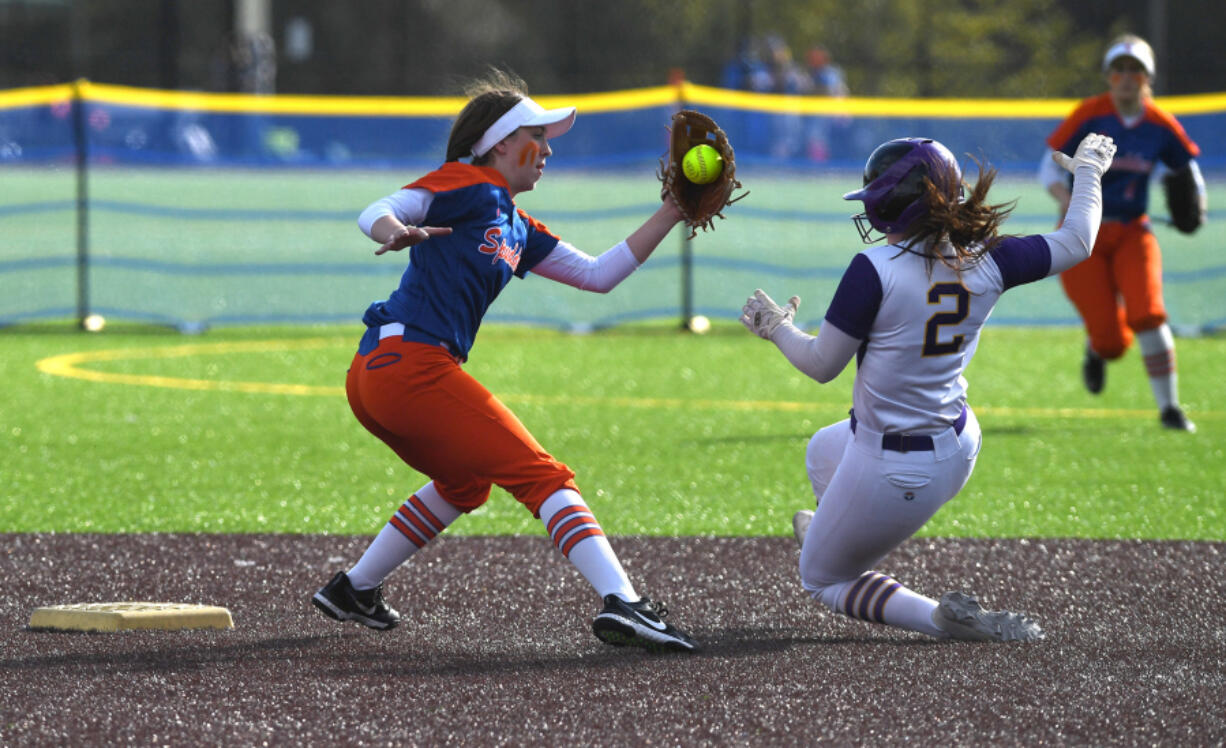 Ridgefield sophomore Mallory Vancleave, left, makes a play at second base Friday, April 22, 2022, during the Spudders' 2-1 win against Columbia River at the Ridgefield Outdoor Recreation Complex.