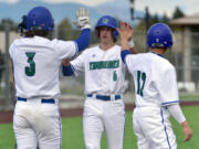 Mountain View's Michael Gordon, center, celebrates with teammates Wednesday, April 27, 2022, during the Thunder's 7-1 win against Heritage at Union High School.