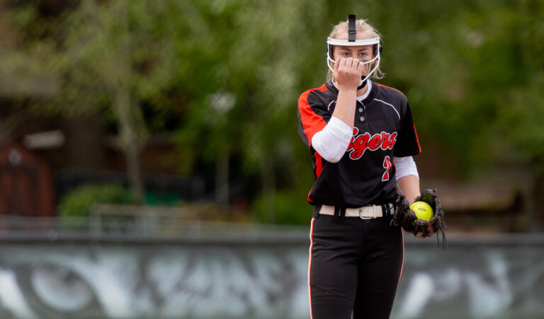 Battle Ground pitcher Rylee Rehbein adjusts her facemask before the start of a 4A Greater St. Helens League softball game on Friday, April 29, 2022, at Battle Ground High School. Skyview beat Battle Ground 2-0.