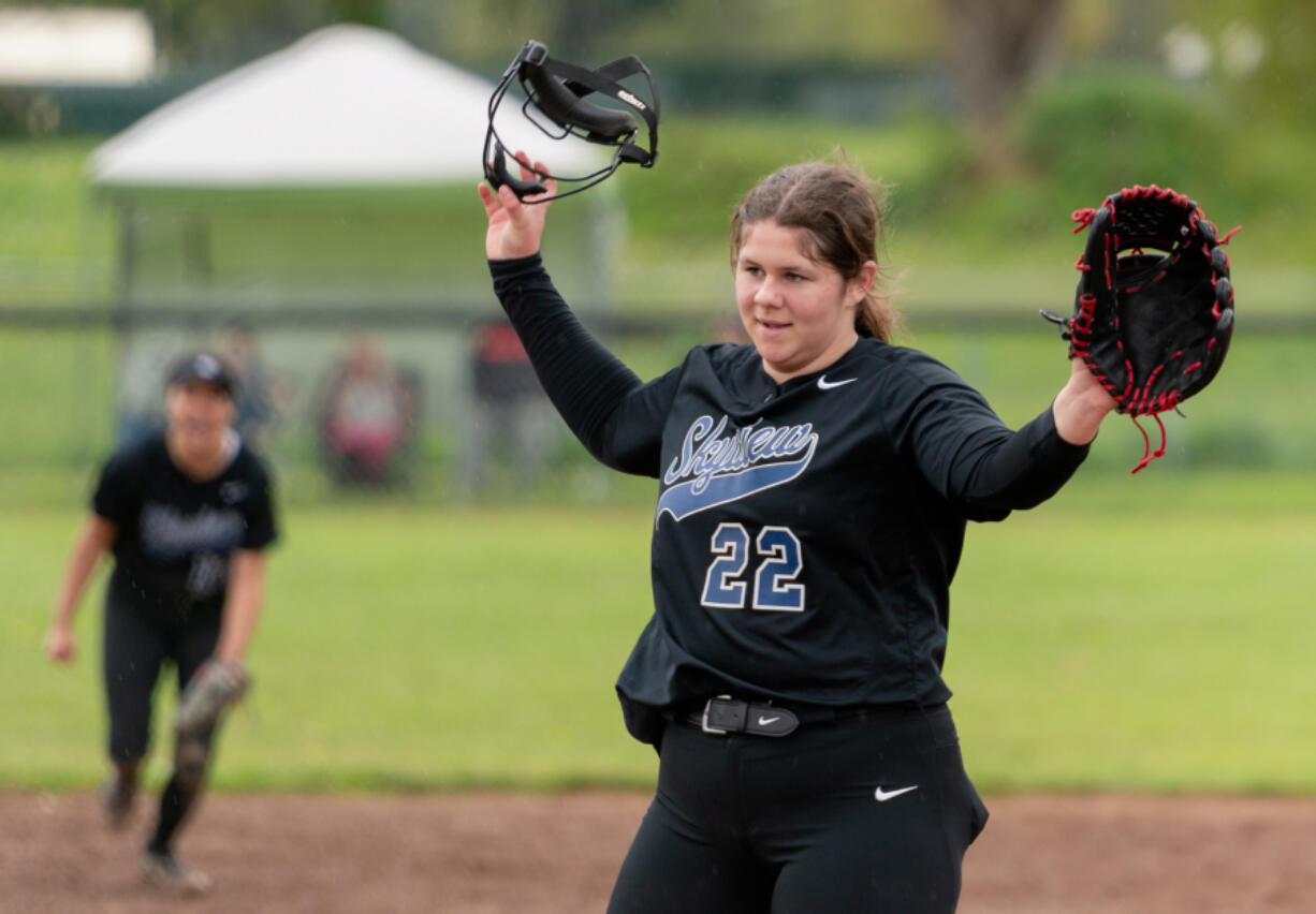 Skyview's Maddie Milhorn sheds her facemask and gives thanks to her catcher after putting the finishing touches on a win in a 4A Greater St. Helens League softball game on Friday, April 29, 2022, at Battle Ground High School. Skyview beat Battle Ground 2-0.