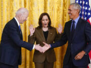 Vice President Kamala Harris reacts as President Joe Biden shakes hands with former President Barack Obama after Obama jokingly called Biden vice president in the East Room of the White House in Washington, Tuesday, April 5, 2022.