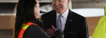 President Joe Biden listens as he tours a construction area at Portland International Airport, Thursday, April 21, 2022, in Portland, Ore.