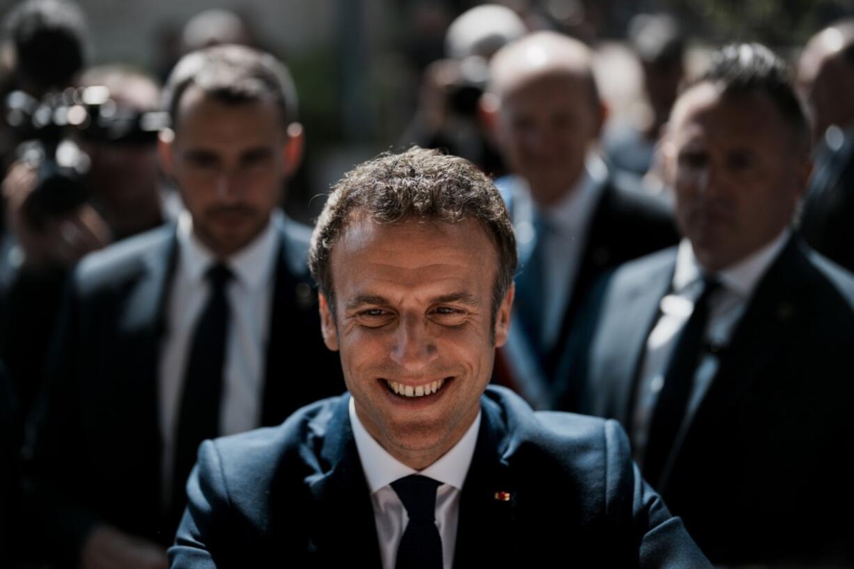 French President and centrist candidate Emmanuel Macron greets well-wishers after casting his vote in Le Touquet, northern France, Sunday, April 24, 2022. France began voting in a presidential runoff election Sunday with repercussions for Europe's future, with centrist incumbent Emmanuel Macron the front-runner but fighting a tough challenge from far-right contender Marine Le Pen.