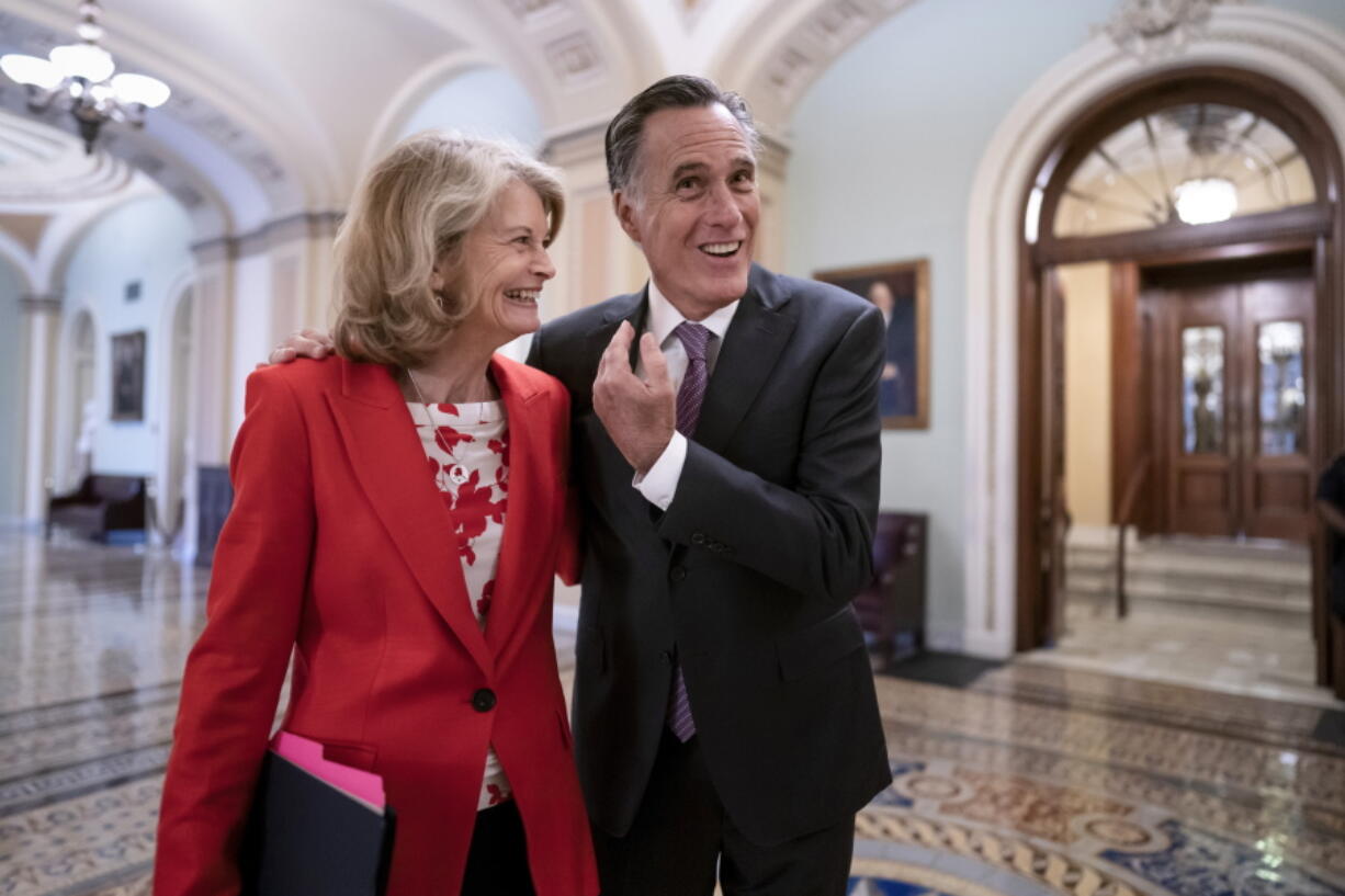 Republican Senators Lisa Murkowski of Alaska, left, and Mitt Romney of Utah, who say they will vote to confirm Judge Ketanji Brown Jackson's historic nomination to the Supreme Court, smile as they greet each other outside the chamber, at the Capitol in Washington, Tuesday, April 5, 2022. Murkowski and Romney join Sen. Susan Collins, R-Maine, who is also bucking the GOP leadership in giving President Joe Biden's nominee a new burst of bipartisan support to become the first Black woman on the high court. (AP Photo/J.