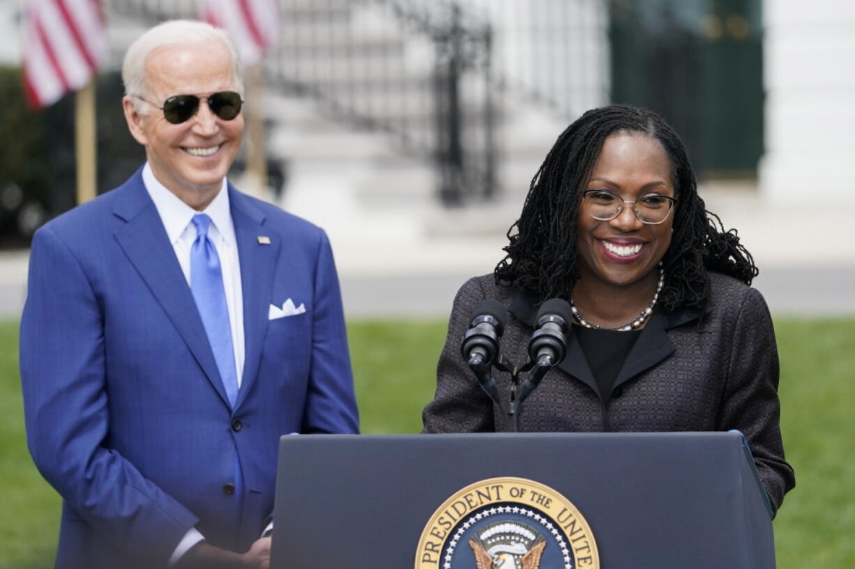 FILE - President Joe Biden listens as Judge Ketanji Brown Jackson speaks during an event on the South Lawn of the White House in Washington, April 8, 2022, celebrating the confirmation of Jackson as the first Black woman to reach the Supreme Court. Overall, 48% of Americans say they approve and 19% disapprove of Jackson's confirmation to the high court according to the new poll from The Associated Press-NORC Center for Public Affairs Research. The remaining 32% of Americans hold no opinion.