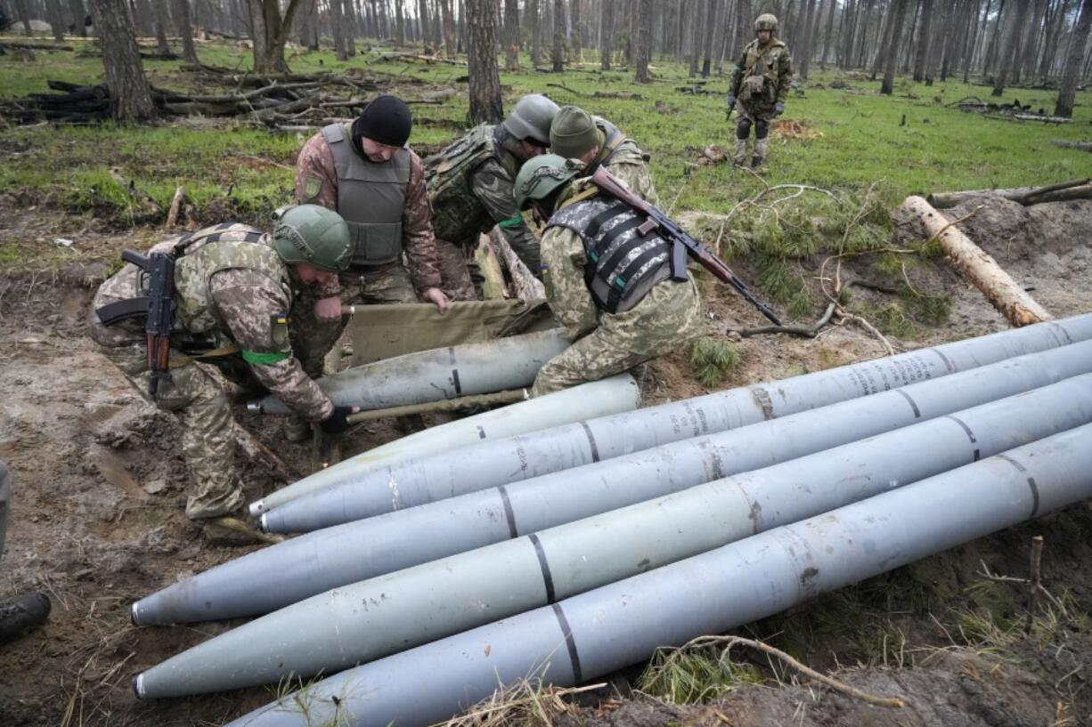 FILE - Ukrainian soldiers collect multiple Russian 'Uragan' missiles after recent fights in the village of Berezivka, Ukraine, April 21, 2022. A majority of U.S. adults say misinformation around Russia's invasion of Ukraine is a major problem, and they largely fault the Russian government for spreading those falsehoods. A new poll from The Associated Press-NORC Center for Public Affairs Research shows 61% of Americans say the spread of misinformation about the war is a major problem, with only 7% saying it's not a problem.